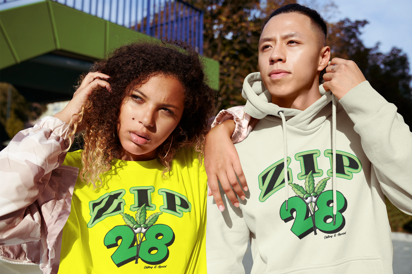 A man and a woman are standing next to each other wearing hoodies.