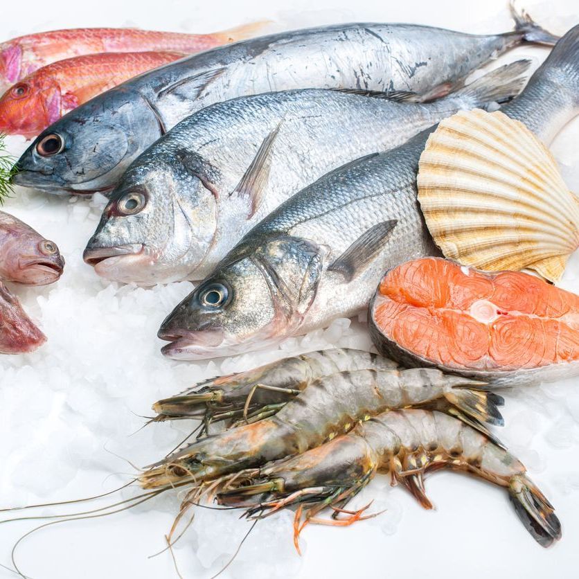 A variety of seafood including shrimp and fish on ice