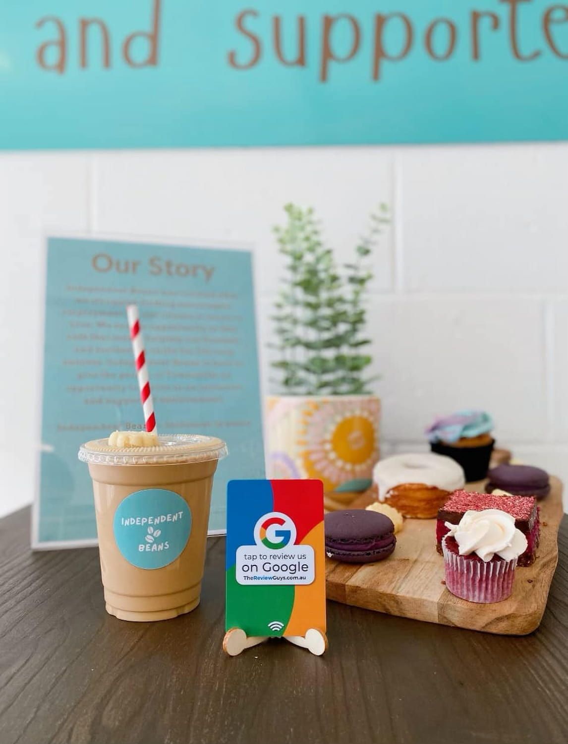 A Cup Of Coffee Next To A Sign That Says Our Story — Independent Beans in Kirwan, QLD