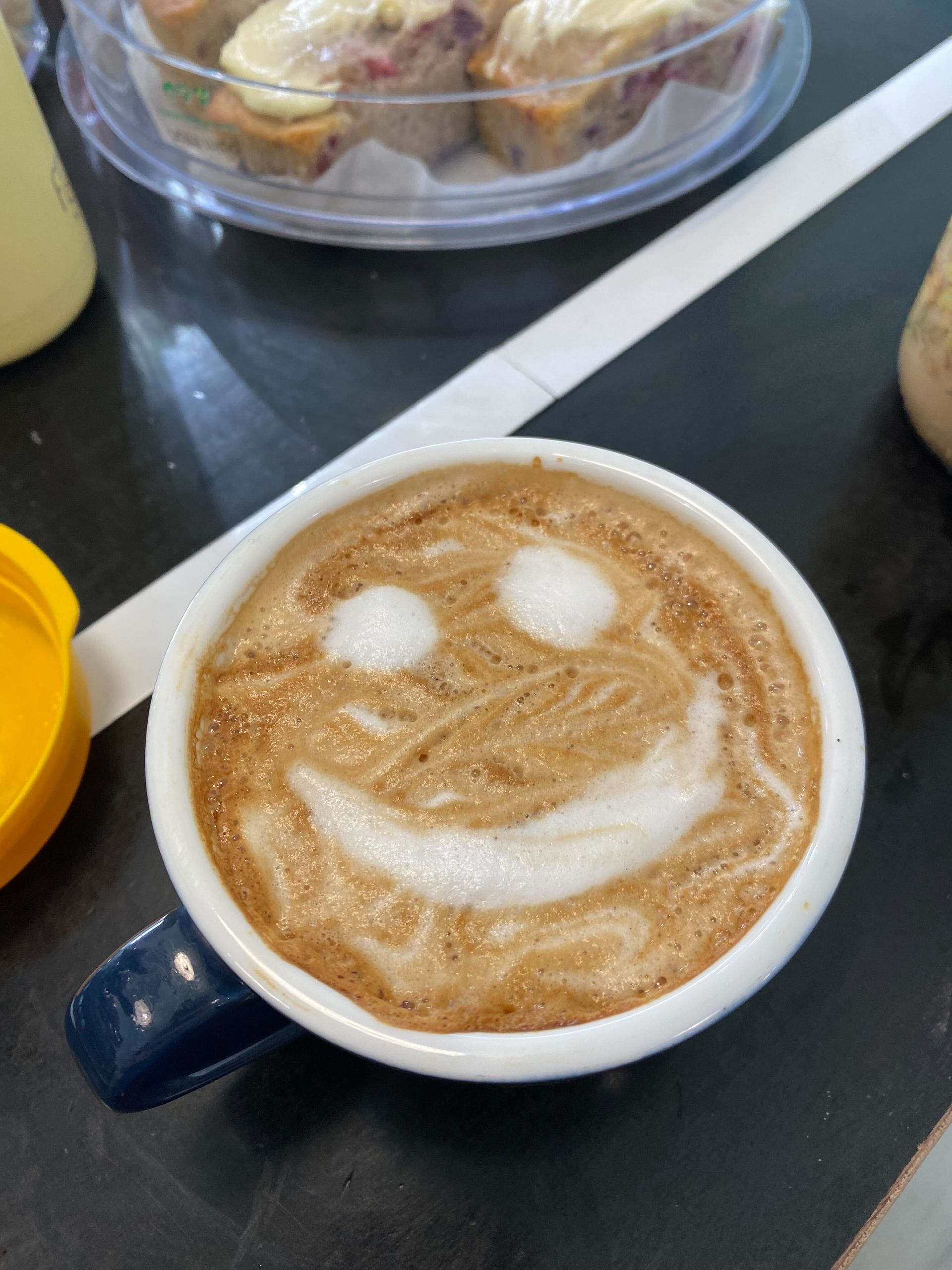 A Cup Of Coffee With A Smile Face Coffee Art On Top — Independent Beans in Kirwan, QLD