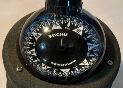 a black compass with the word ritchie on it