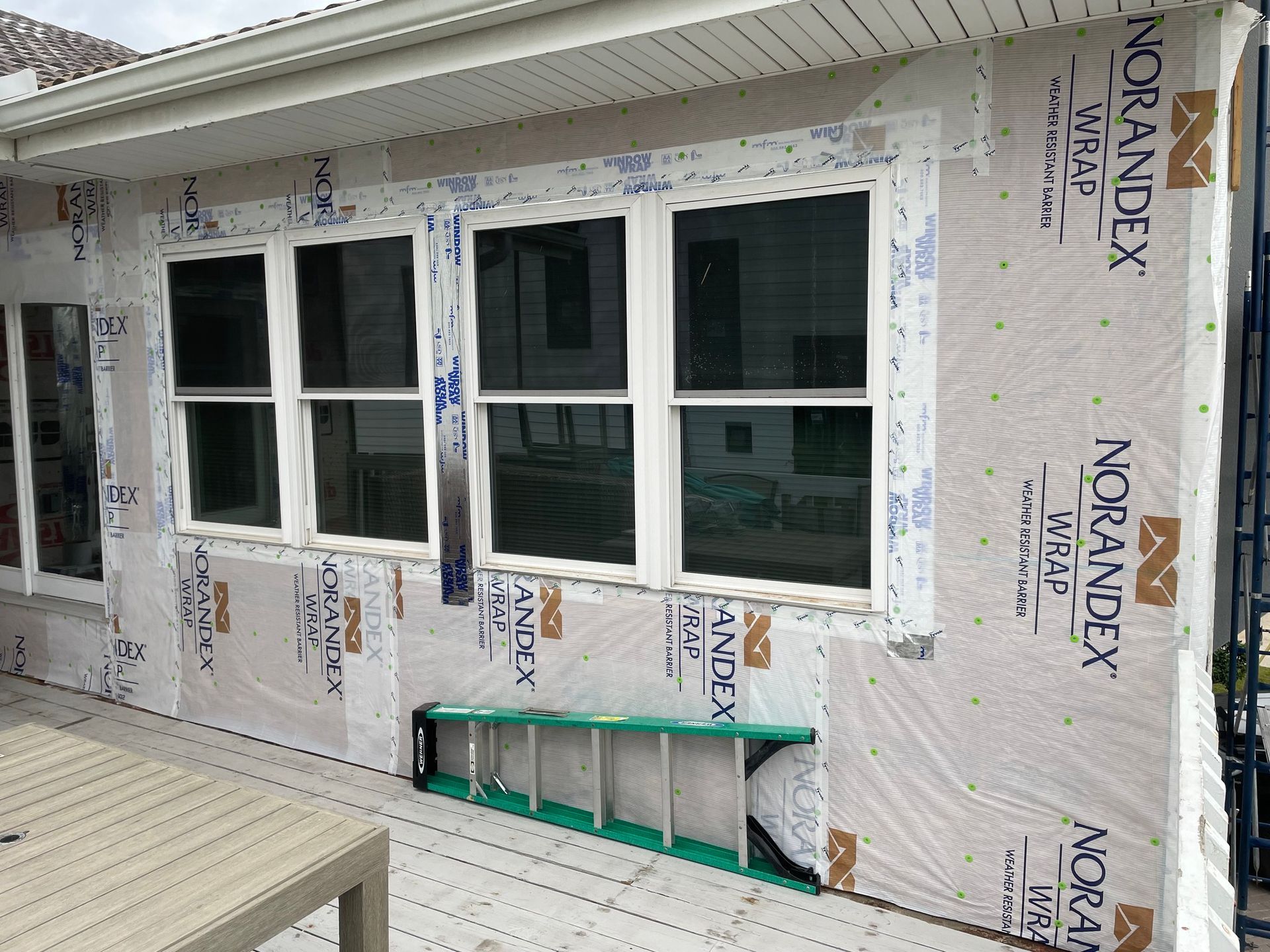 A house with a white garage door and a black roof.