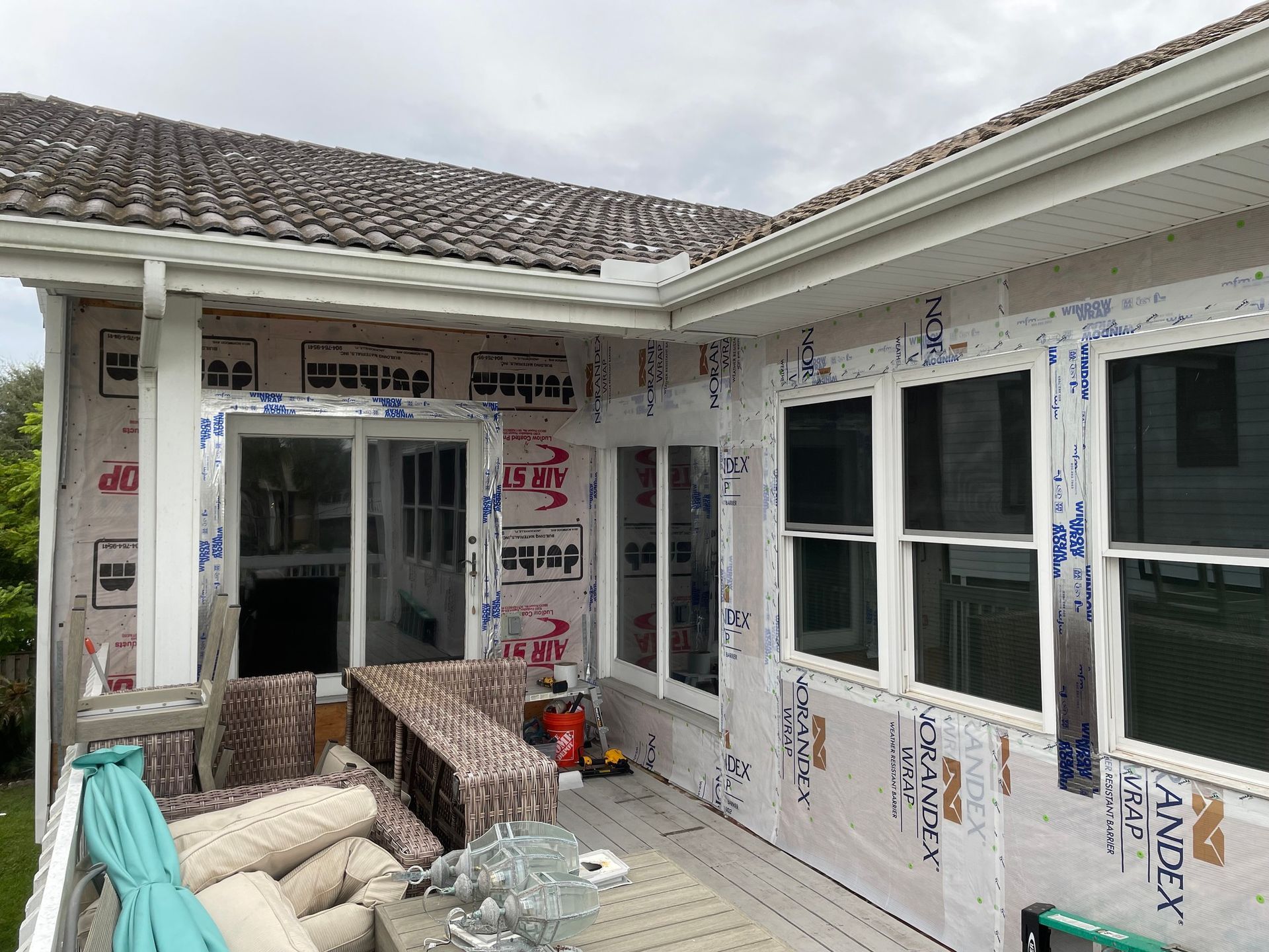 A large house with a brown roof and white trim