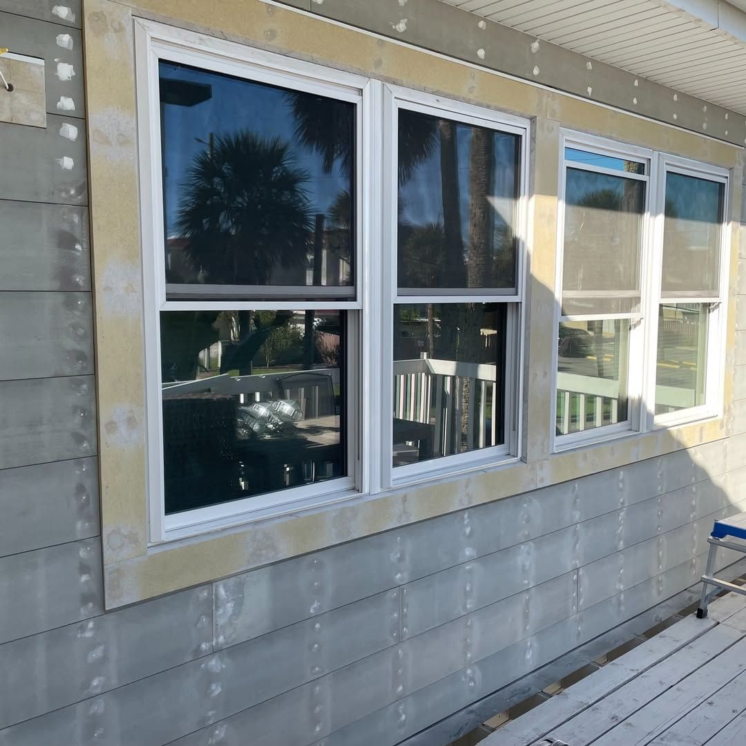 A white house with red shutters on the windows