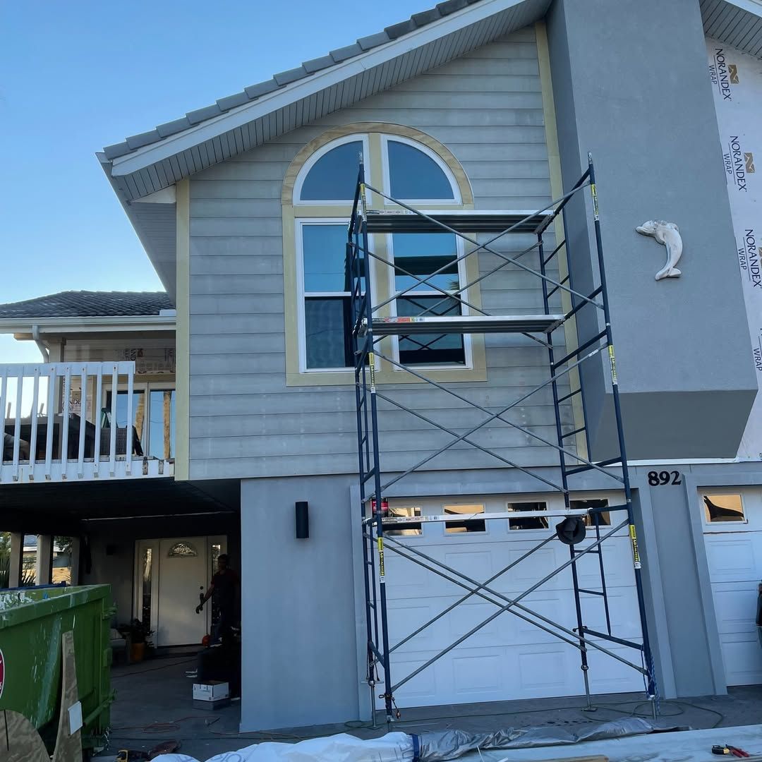 A large yellow house with a gray roof