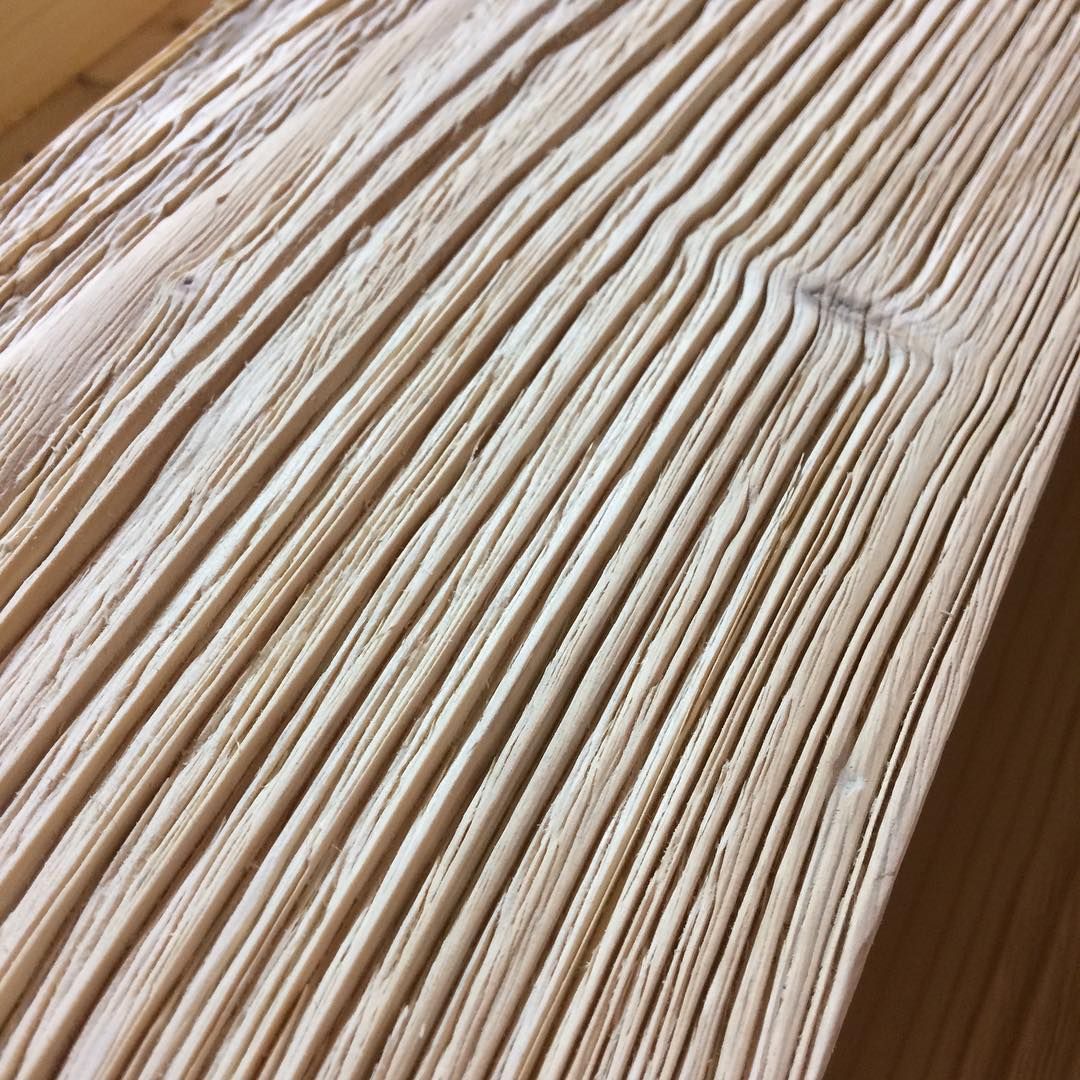 An empty living room with hardwood floors and a white door.