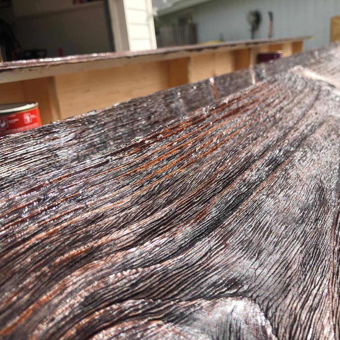 A small house with a lush green lawn and flowers in front of it.