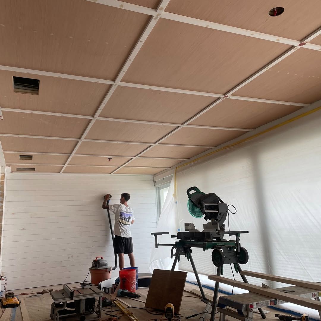 A large white house with a large porch and a lot of windows.