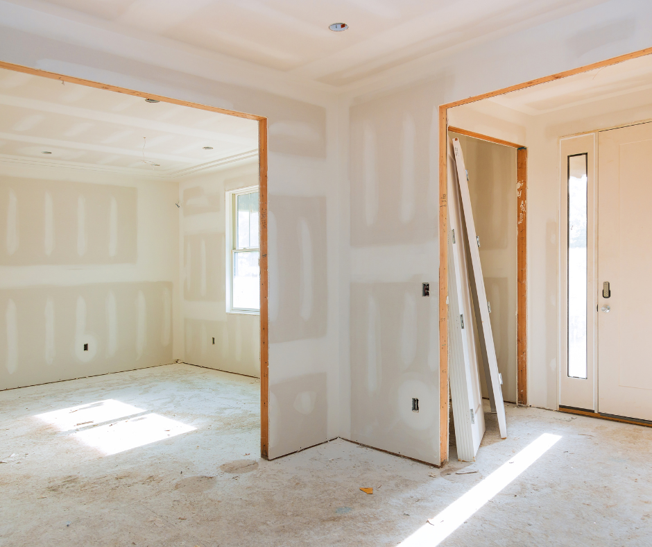 An empty room with drywall on the walls and a door