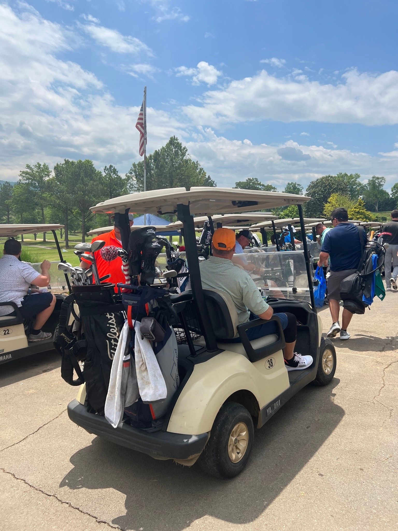 A man is sitting in a golf cart at a golf course.
