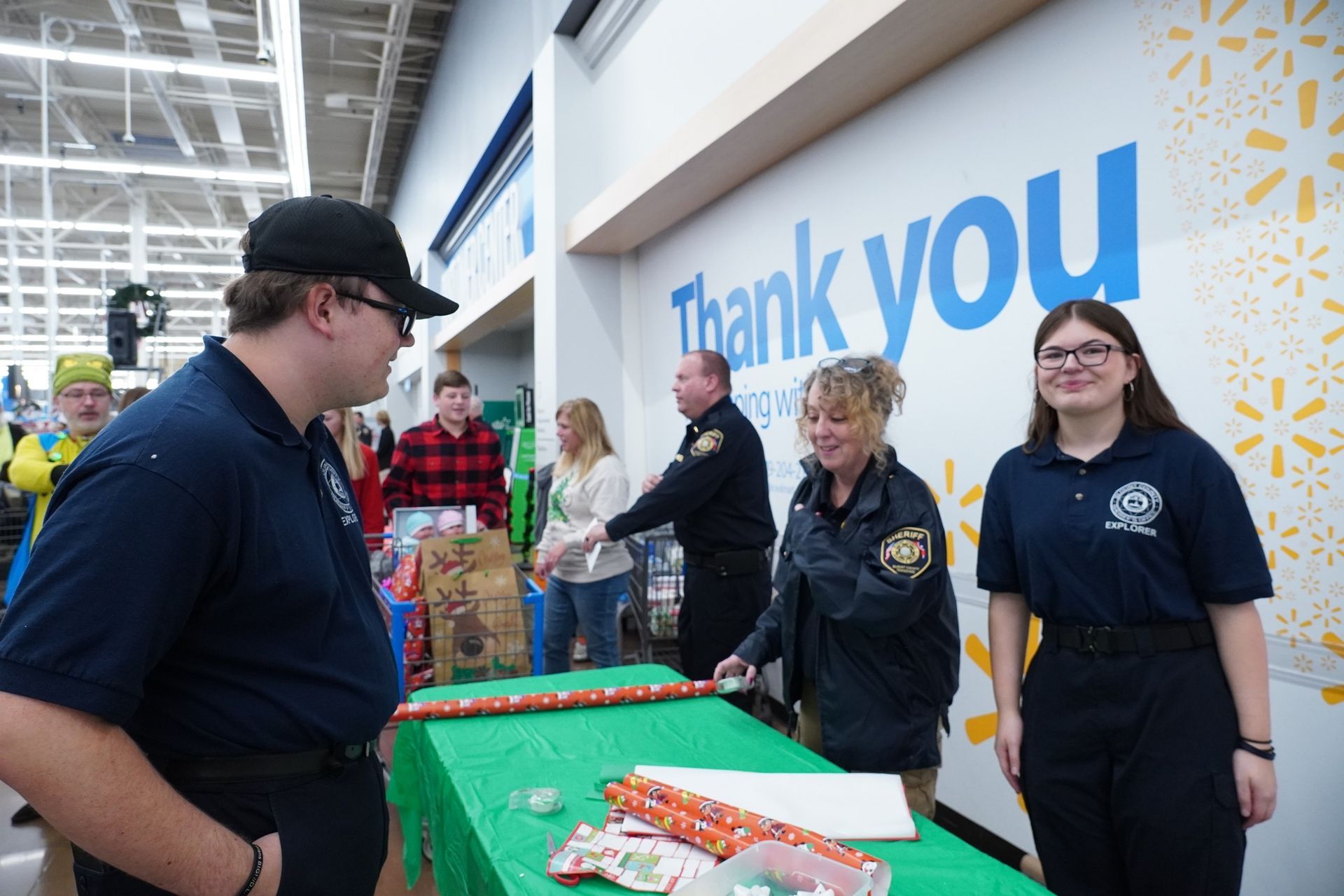 A group of people are standing around a table in a store.