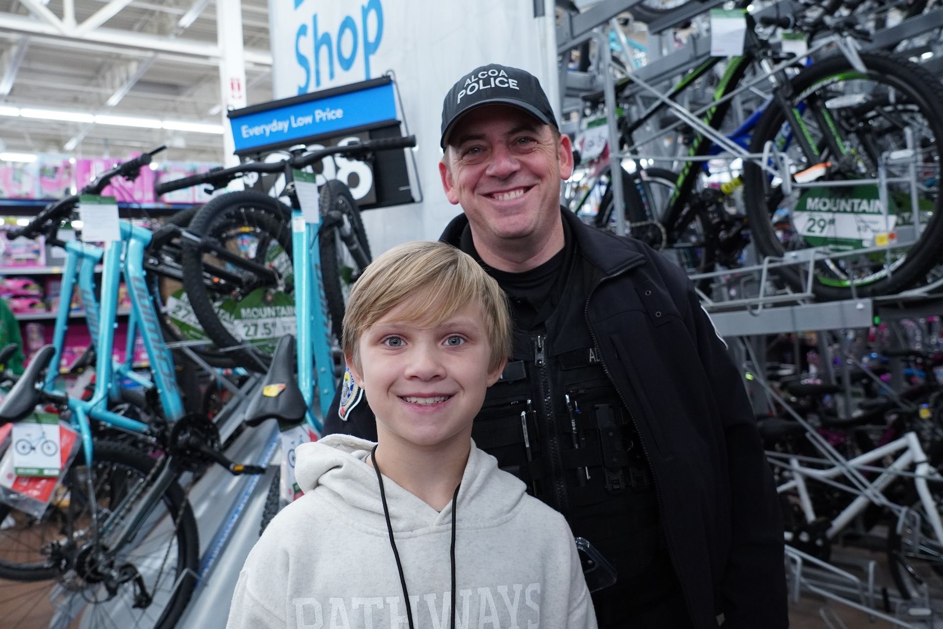 A man and a boy are posing for a picture in a store.