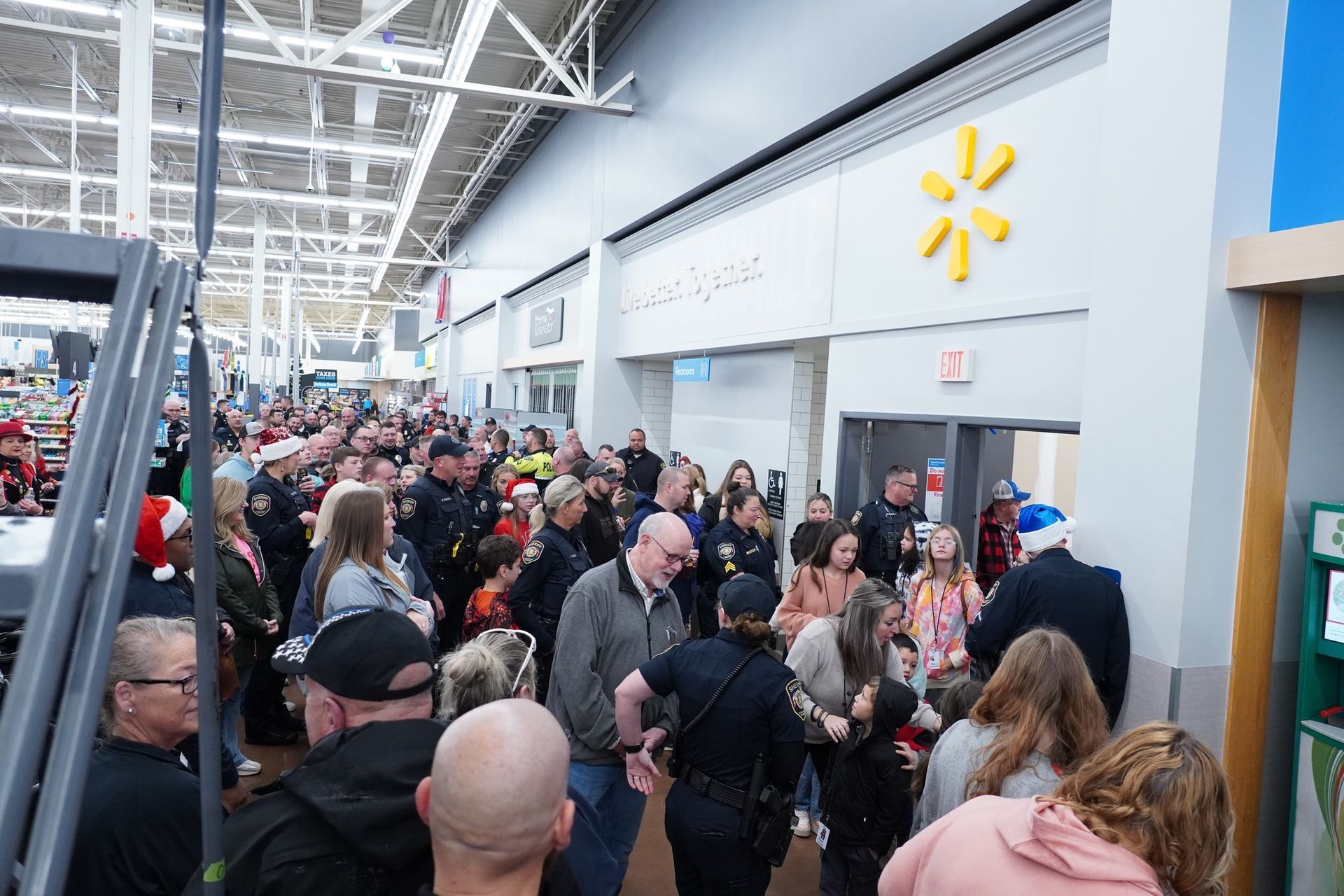 A large group of people are standing in a store.