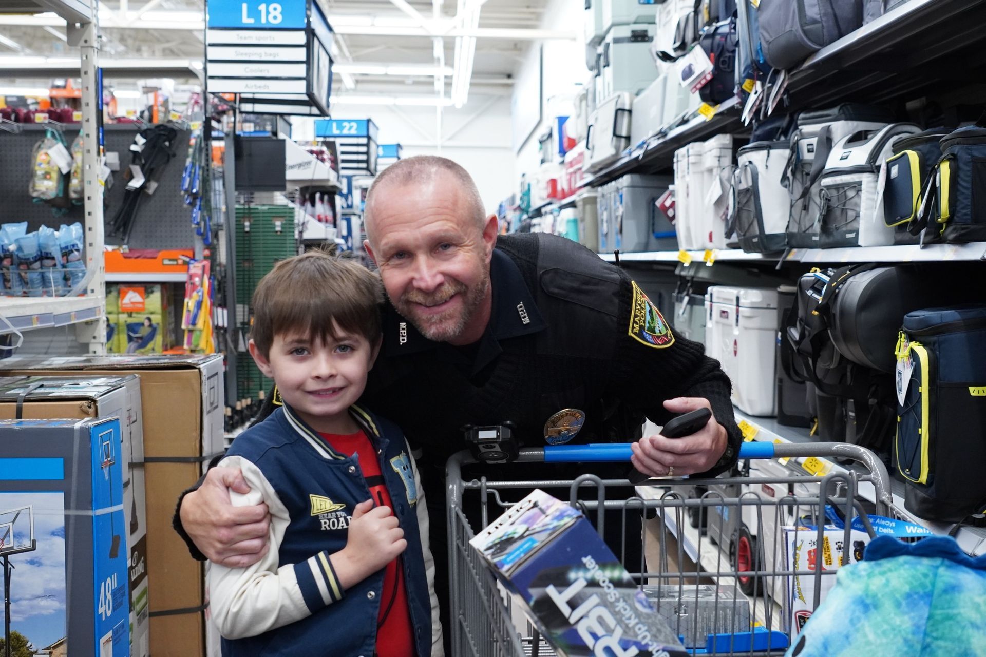 A man and a boy are posing for a picture in a store.