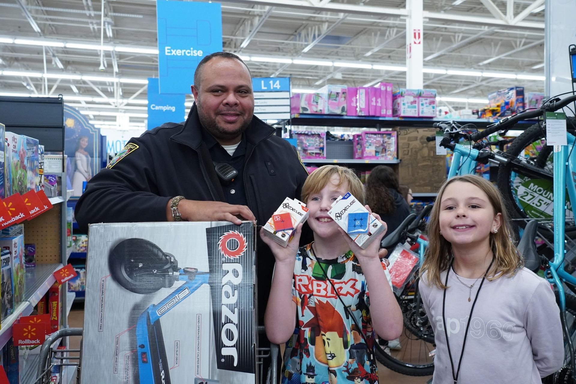 A man and two children are posing for a picture in a store.