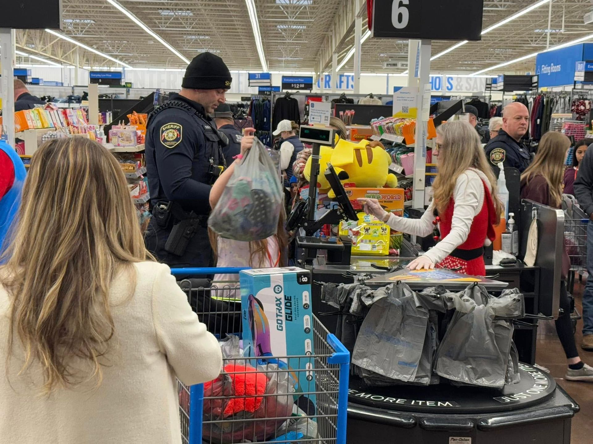 A group of people are standing in a grocery store.