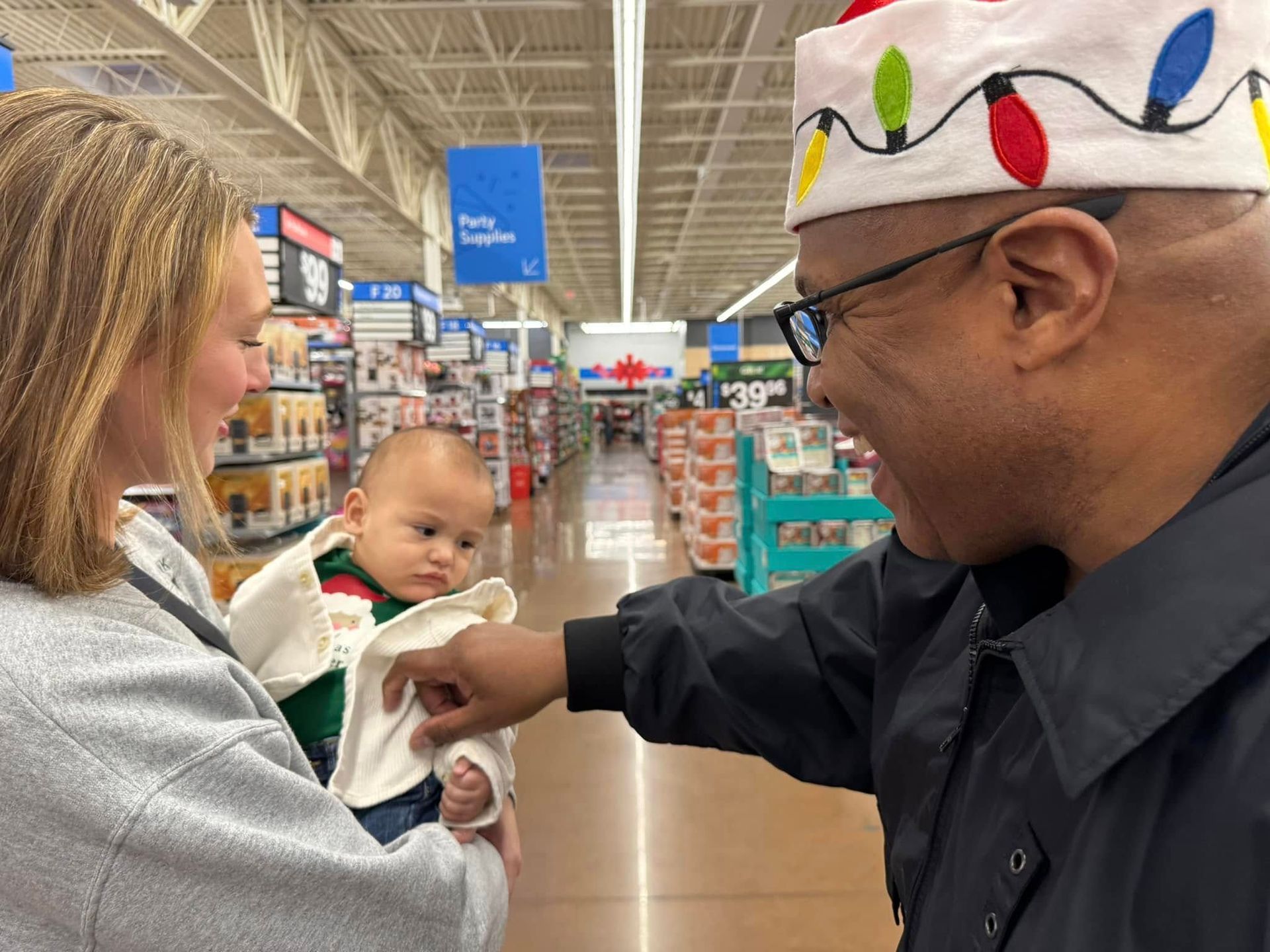 A man and a woman are holding a baby in a store.