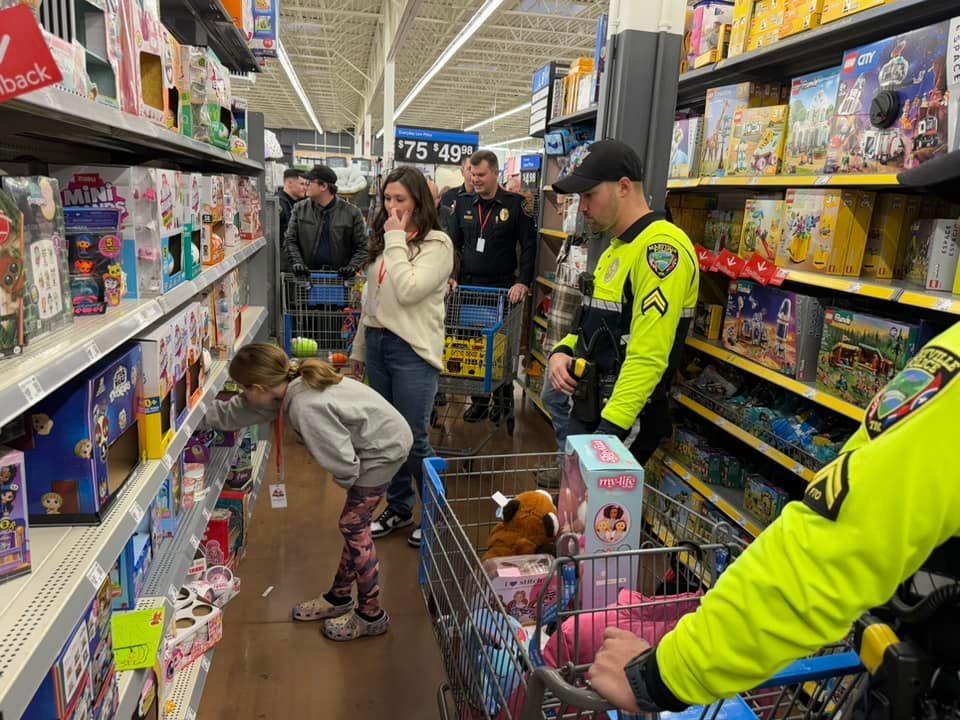 A group of people are shopping in a walmart store.