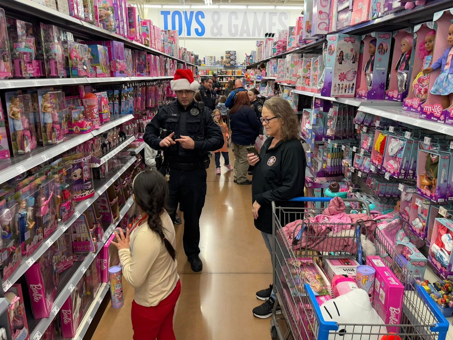 A group of people are shopping in a toy store.
