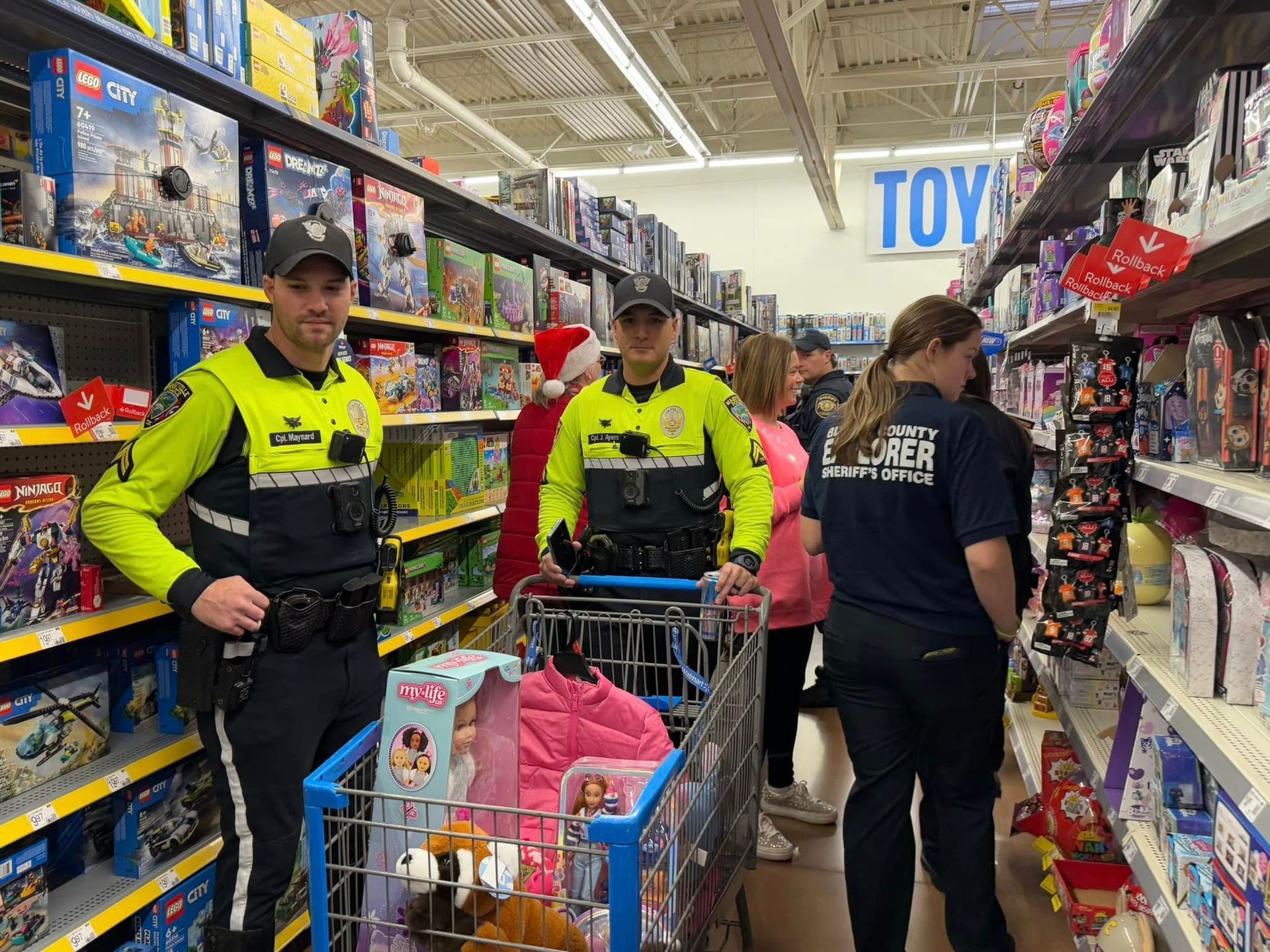 A group of police officers are standing in a toy store.