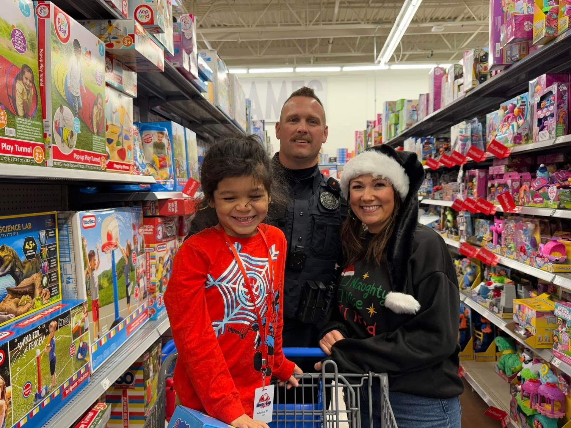 A man , woman and child are shopping in a toy store.