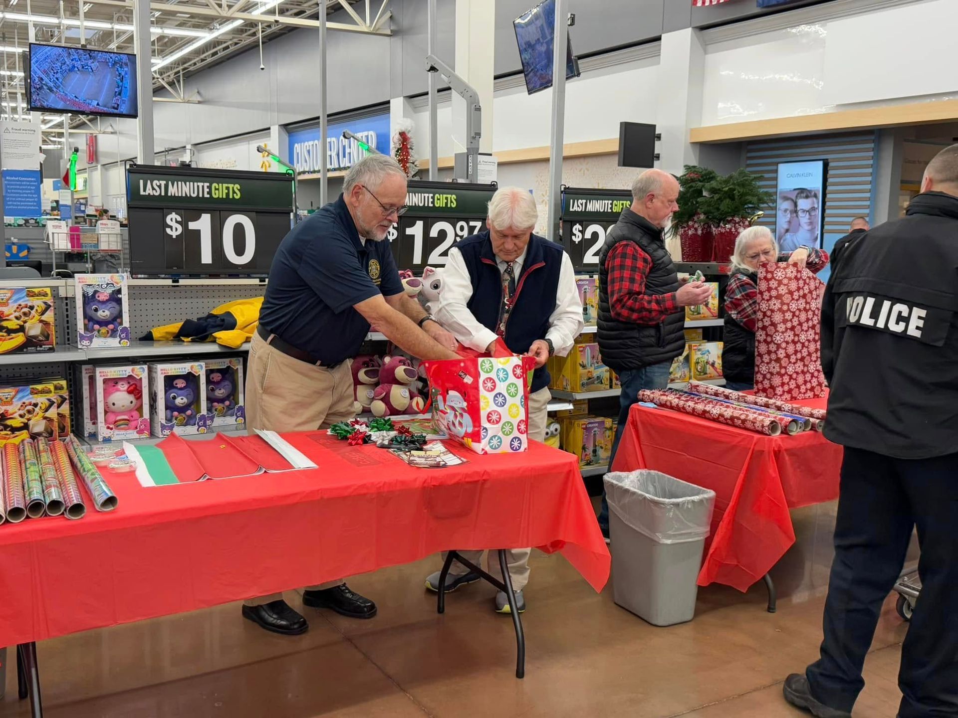 A group of people are standing around a table in a store.
