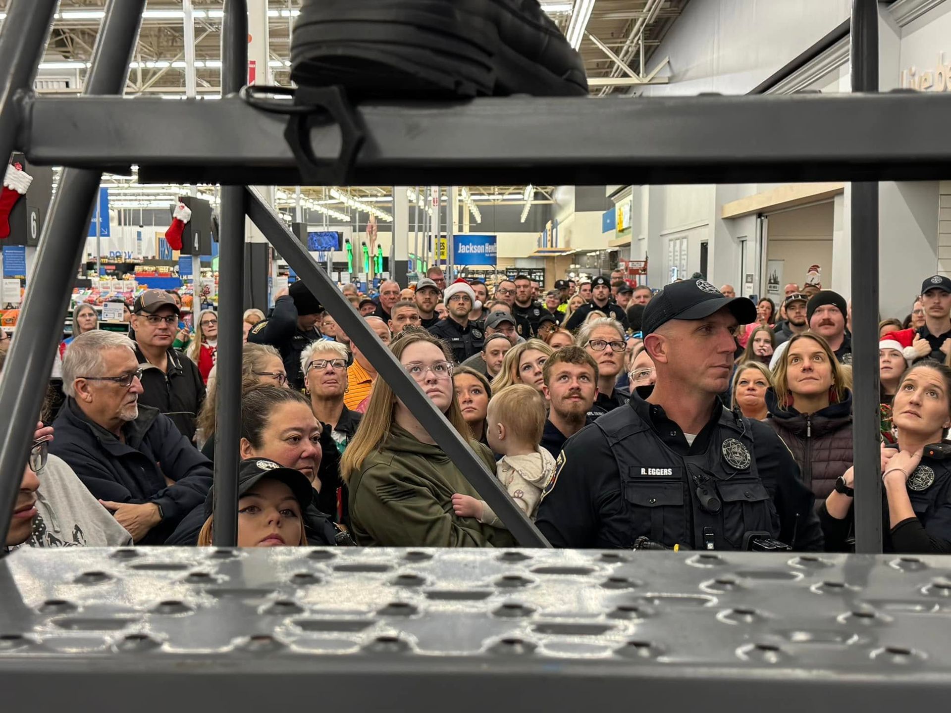 A large group of people are standing in a store.