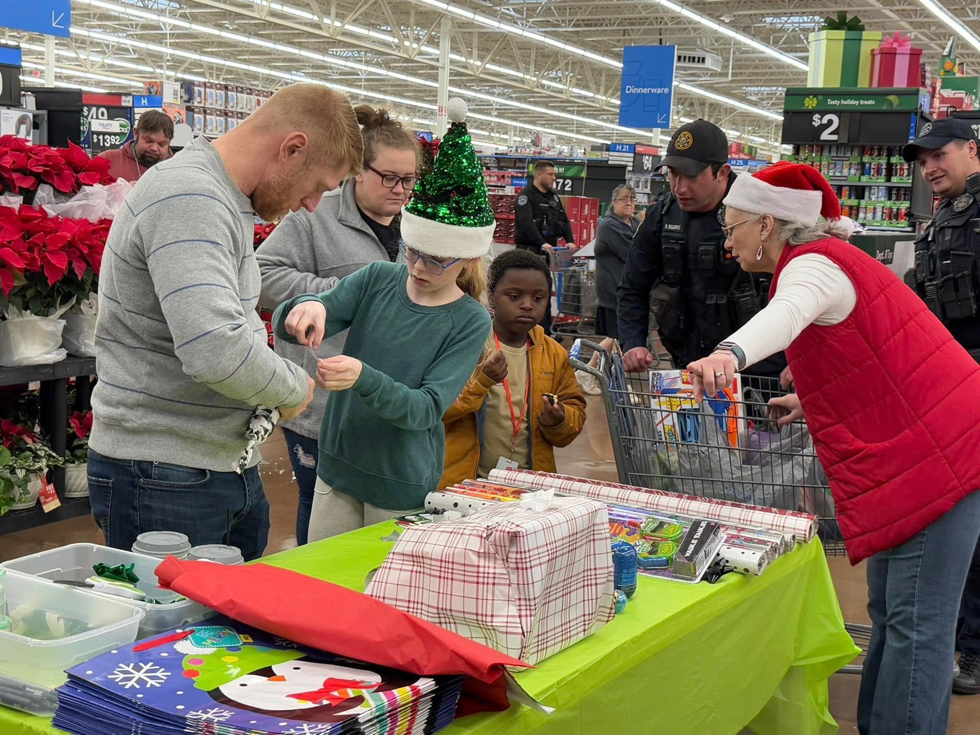 A group of people are standing around a table in a store.
