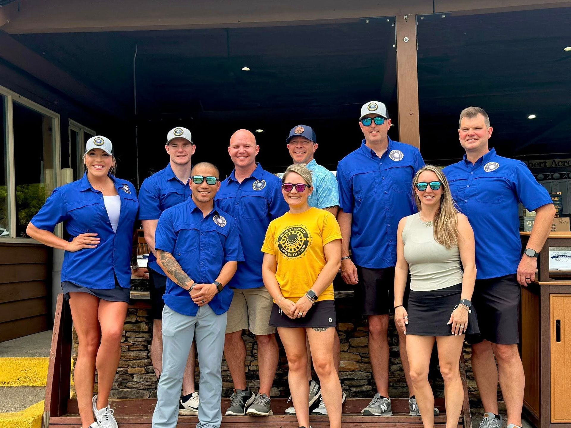 A group of people are posing for a picture in front of a building.