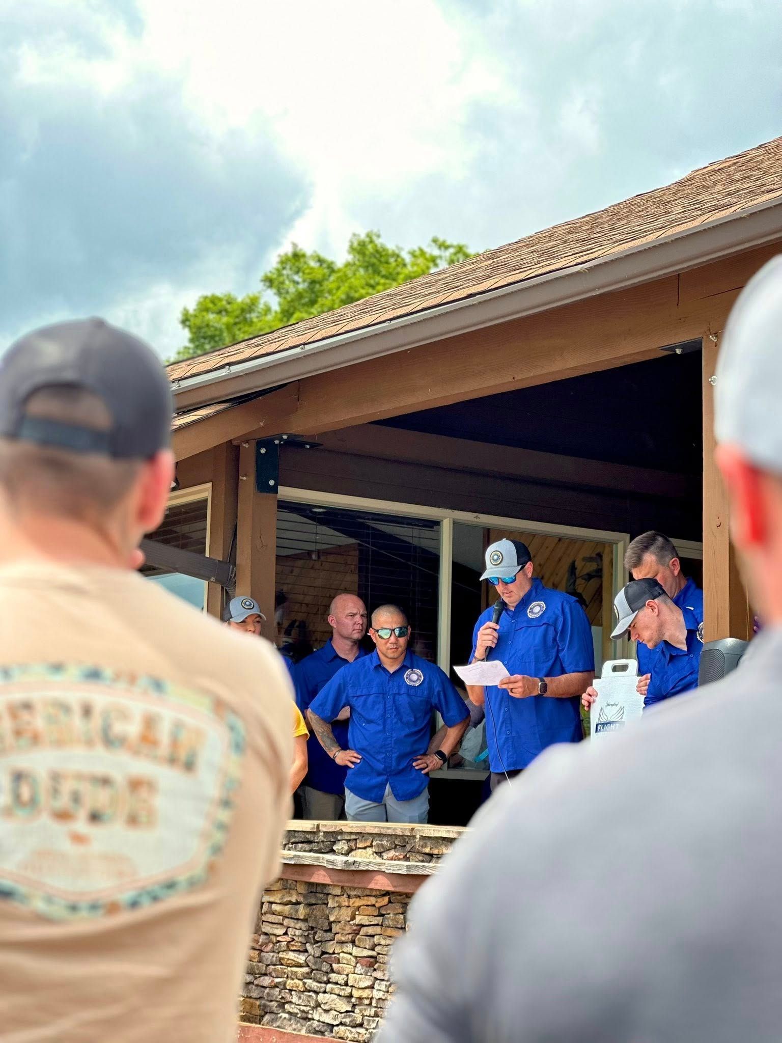 A group of men are standing in front of a building.