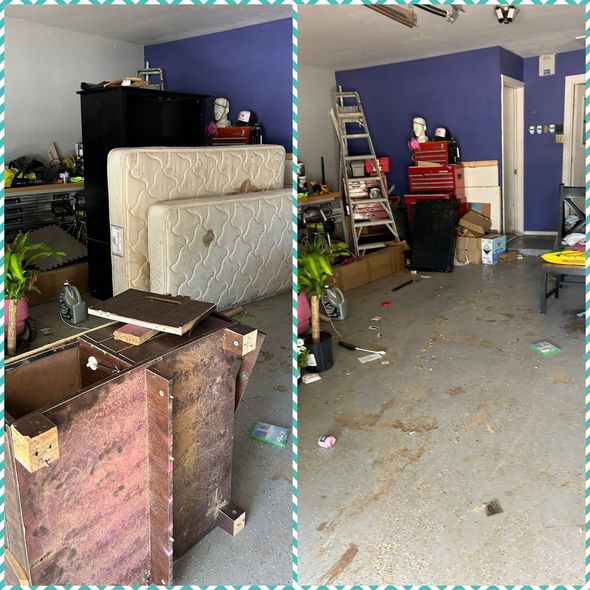 A cluttered garage with tools, mattresses, and furniture against purple walls.