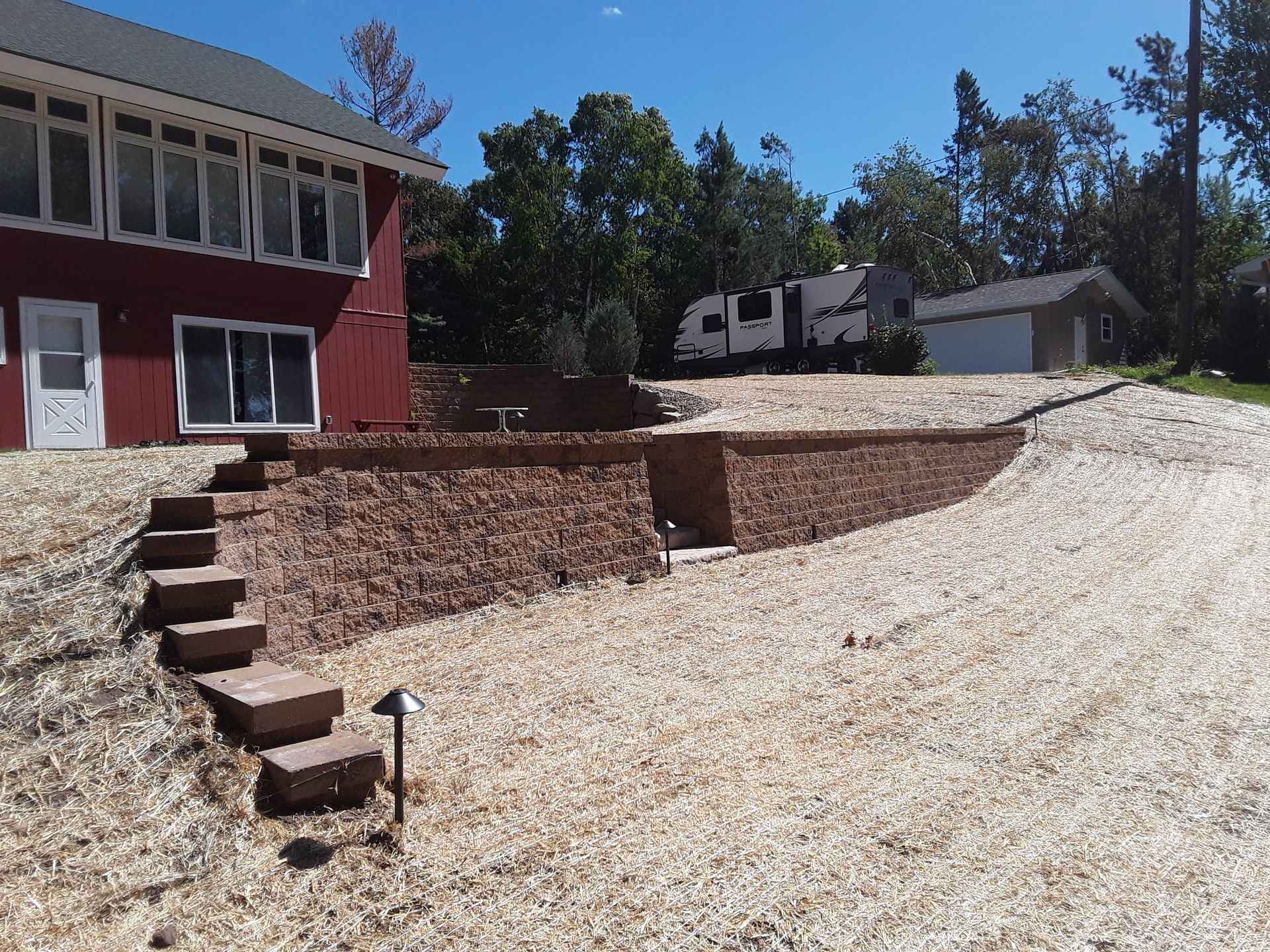 A red house with stairs leading up to it