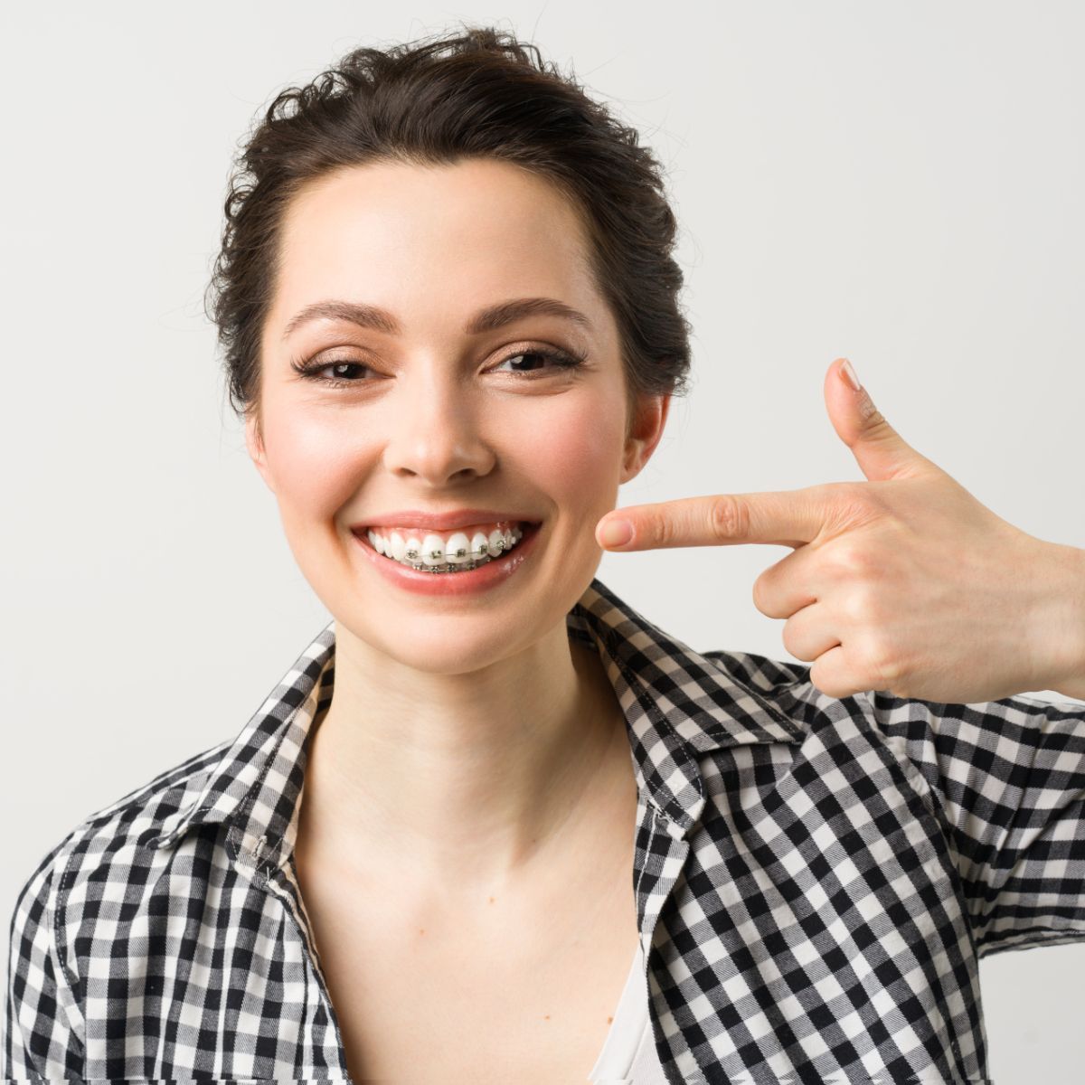 Woman looking at her new smile in the mirror