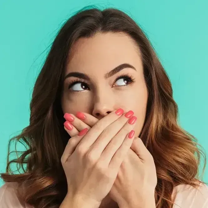 woman covering her smile