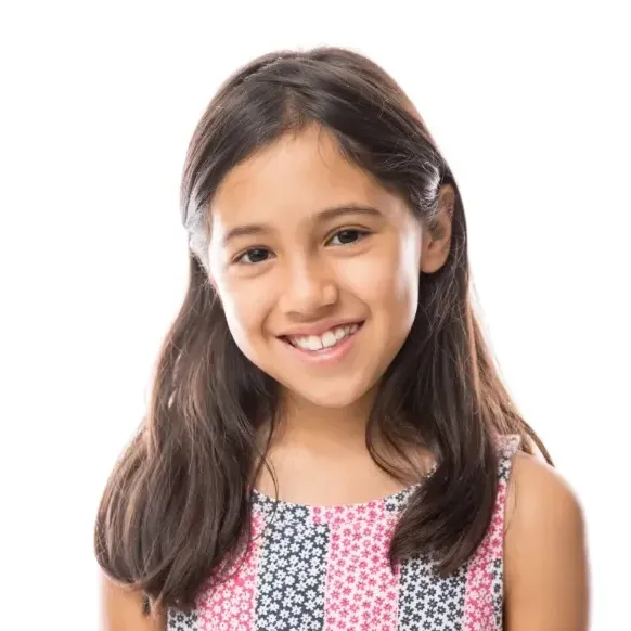 little girl, looking straight at the camera, laughing and showing her smile