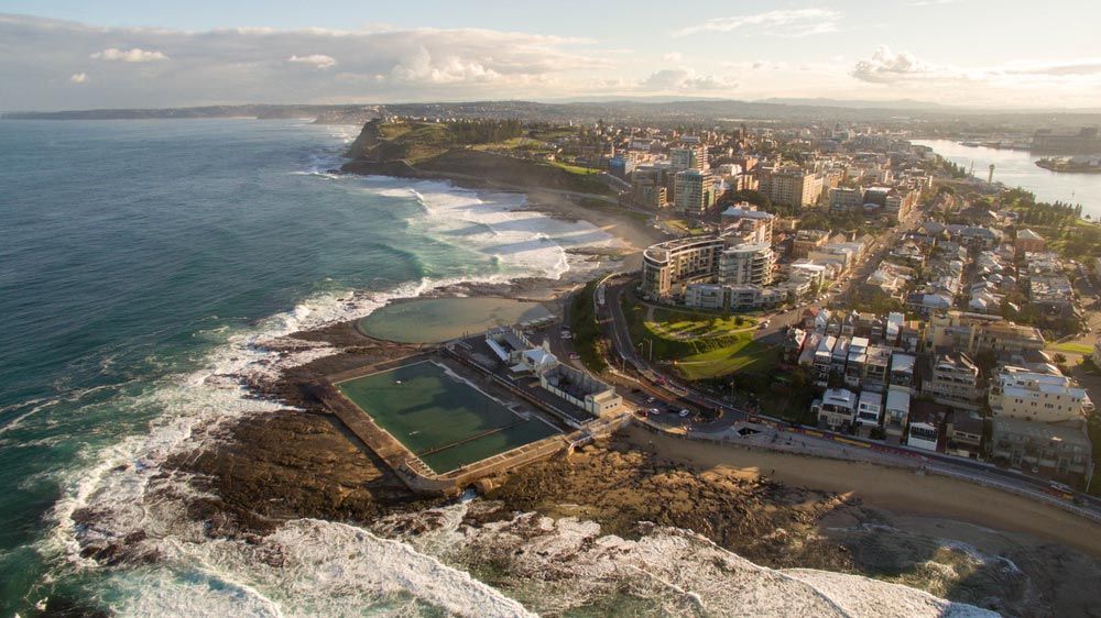 An Aerial View Of A City Next To A Body Of Water — Tim's Towing and Transport In Newcastle, NSW