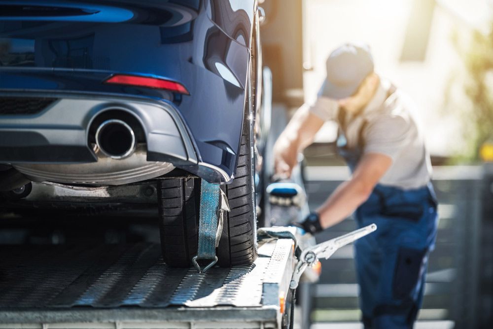 A Man Is Towing A Car On A Tow Truck — Tim's Towing and Transport In Lambs Valley, NSW