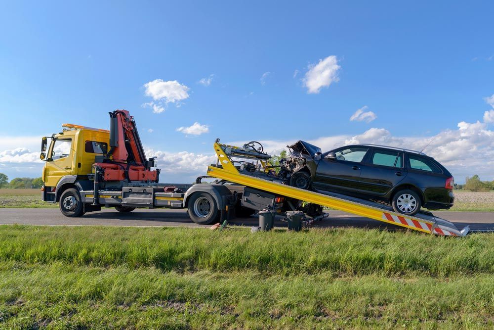 A Tow Truck Is Towing A Car On A Ramp — Tim's Towing and Transport In Warners Bay, NSW