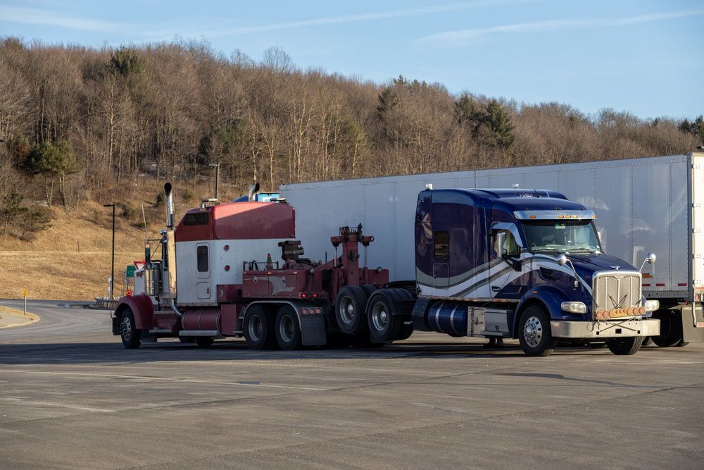 A Semi Truck With A Tow Truck Attached — Tim's Towing and Transport In Kurri Kurri, NSW