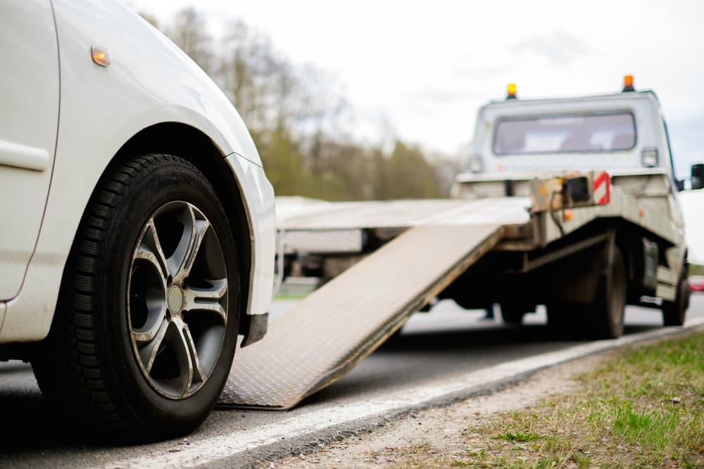 Loading A Car In A Tow Truck — Tim's Towing and Transport In Greta, NSW