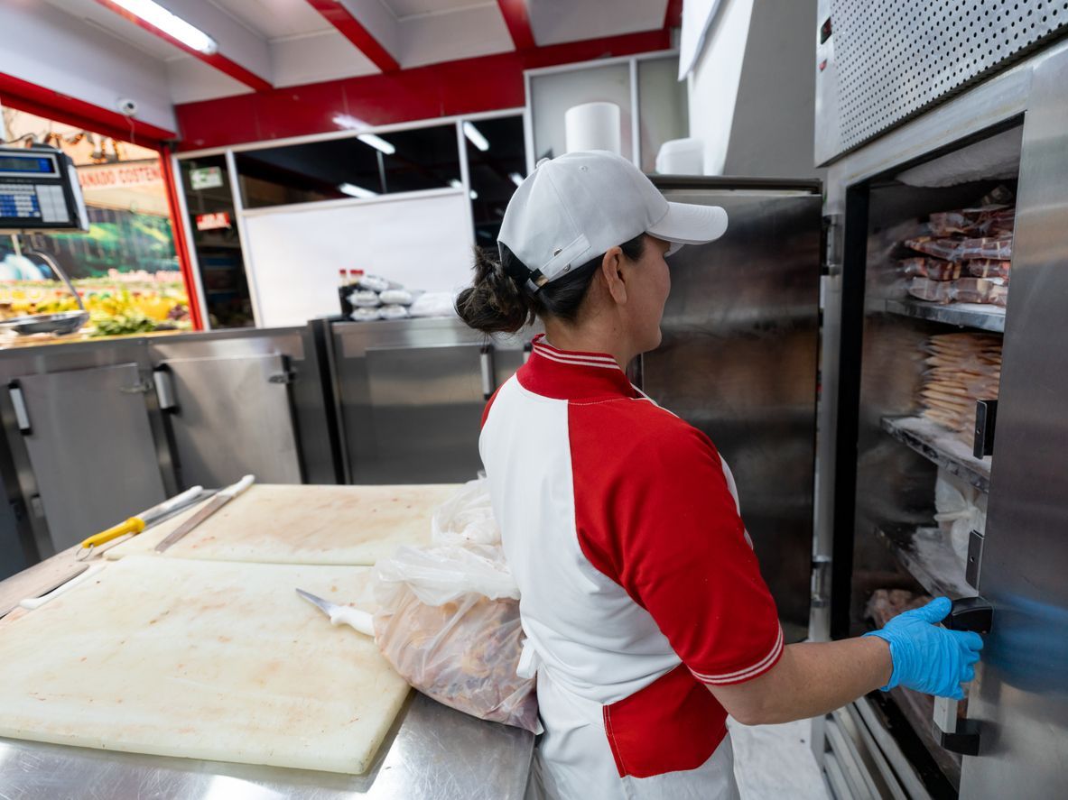 female opening commercial freezer