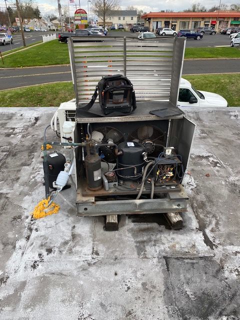 Old refrigeration unit being worked on or replaced