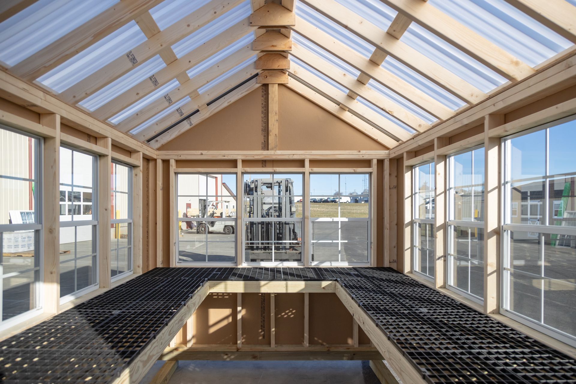 A greenhouse with a lot of windows and a clear roof.