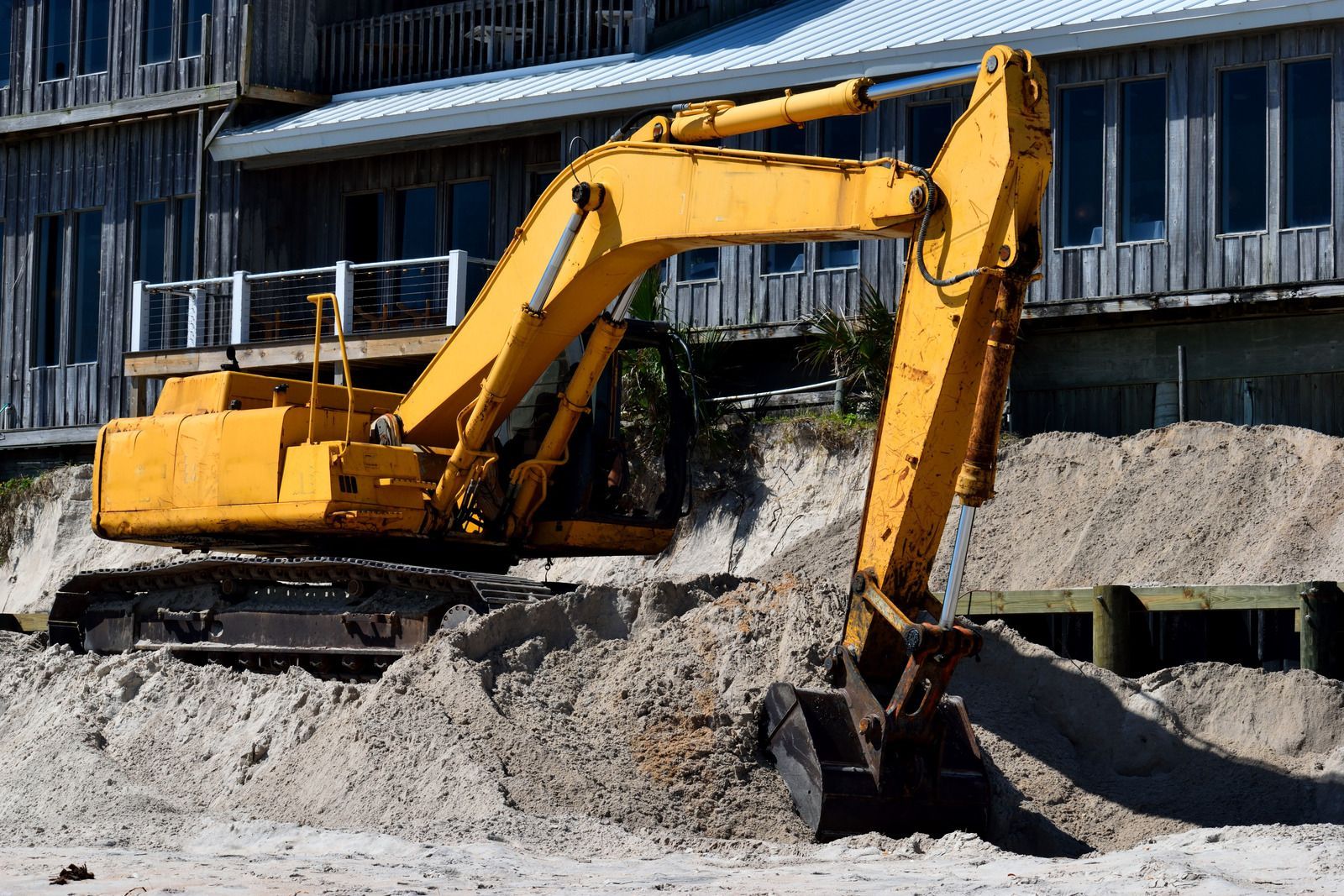 A white truck is parked in a parking lot next to a building.