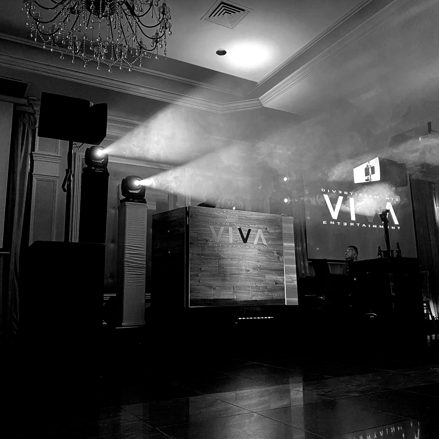 a black and white photo of a stage with a sign that says viva on it .