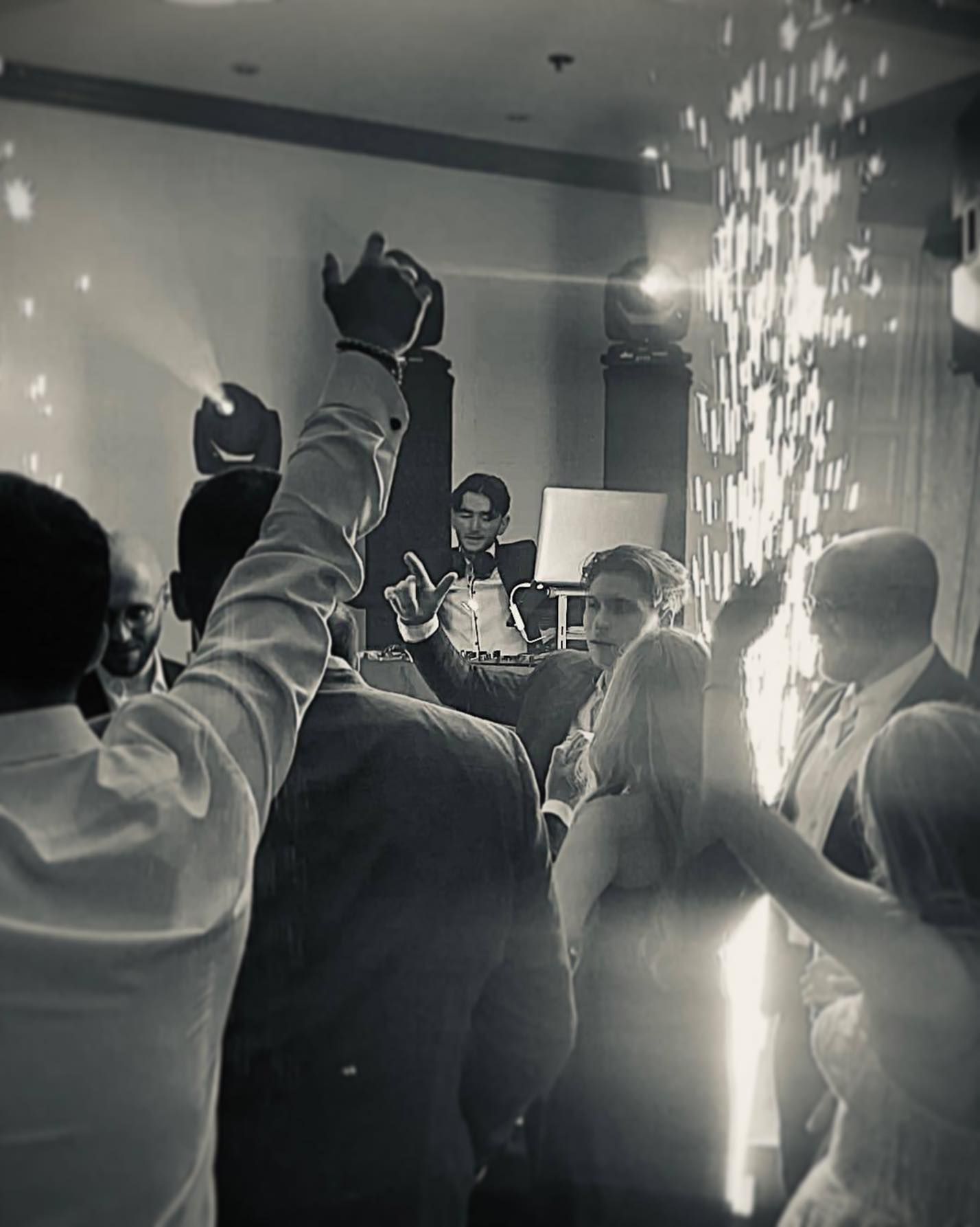 a black and white photo of people dancing at a party