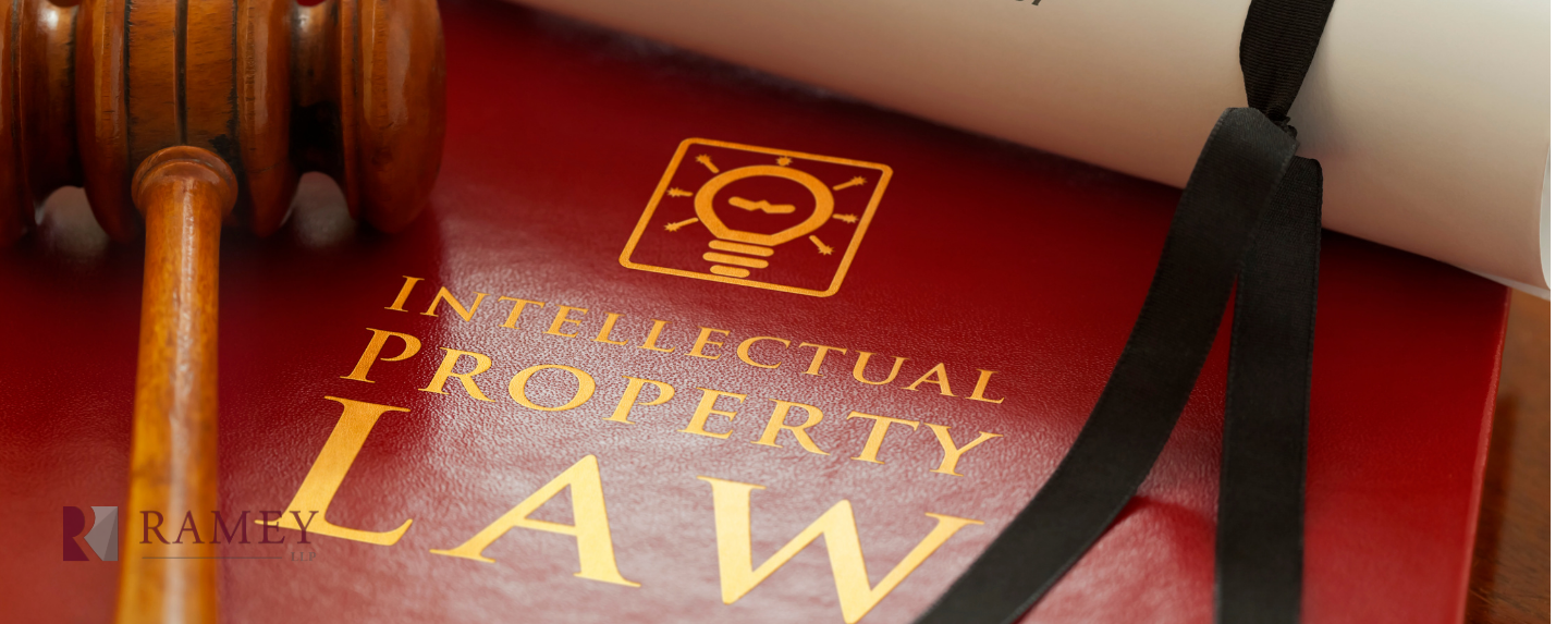 A wooden gavel is sitting on top of a red book titled intellectual property law.