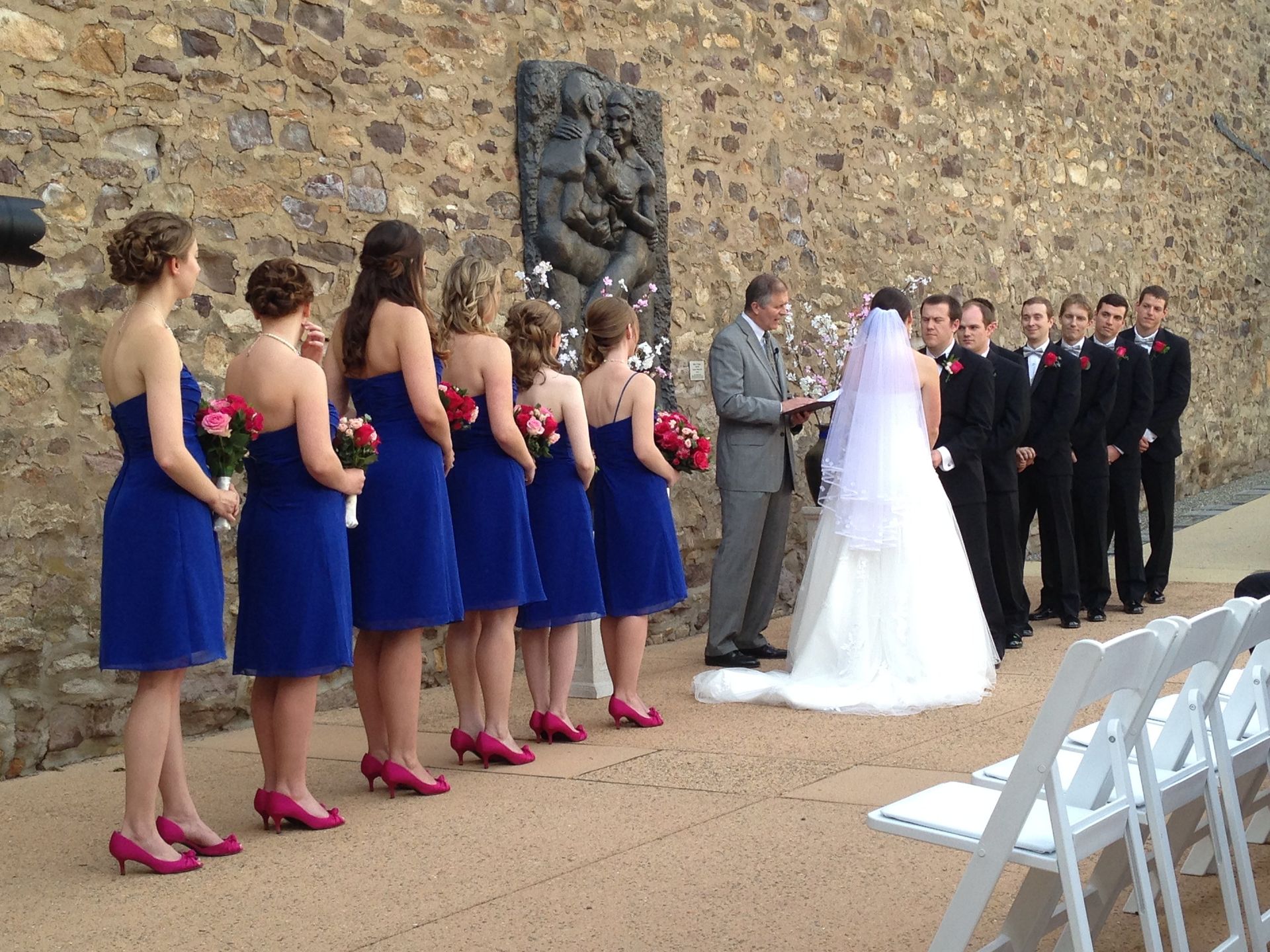 outdoor wedding ceremony with bridesmaids wearing blue dresses