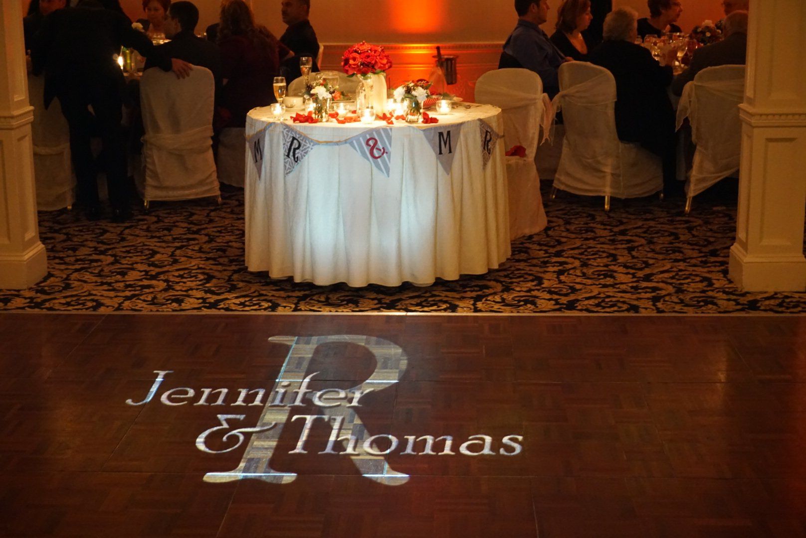 custom projected monogram on dance floor at wedding