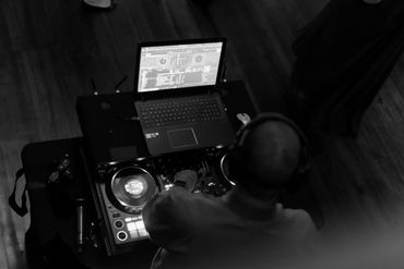 wedding dj playing music with headphones on head